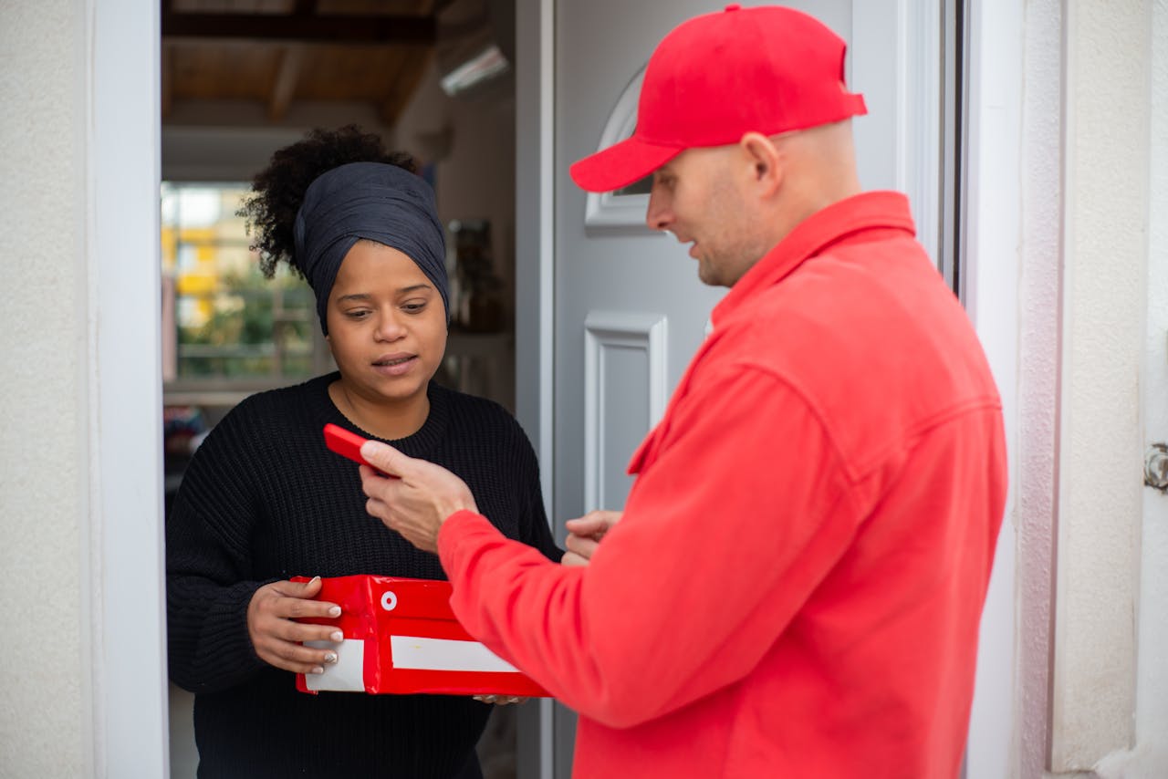 creative-02 Professional delivery service with a person receiving a red package at their doorstep.